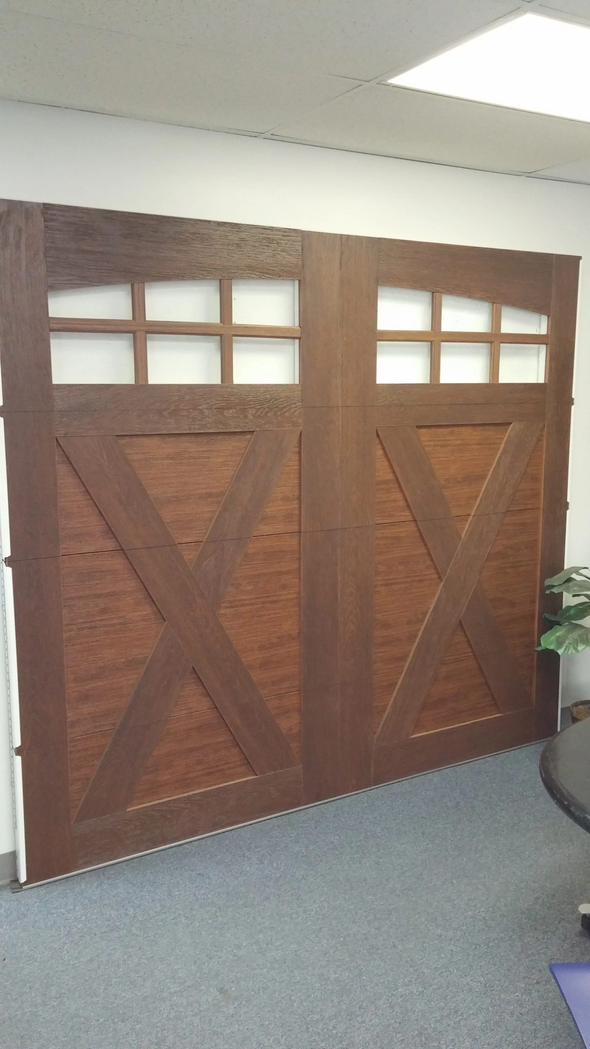 Service van parked at a ranch home with new wood-grain single garage door